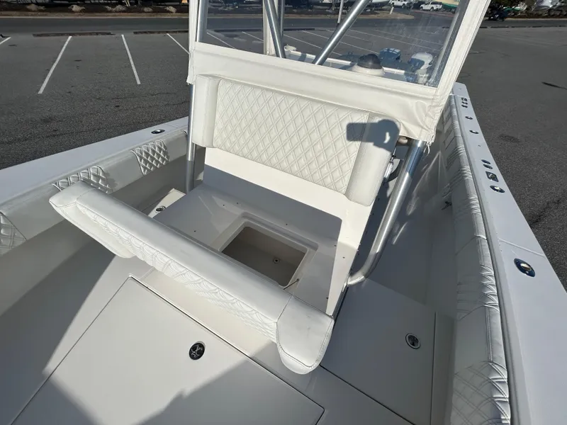 Slide: The Image of 2000 Regulator 32 Classic boat interior with white seating and storage compartment. - 28