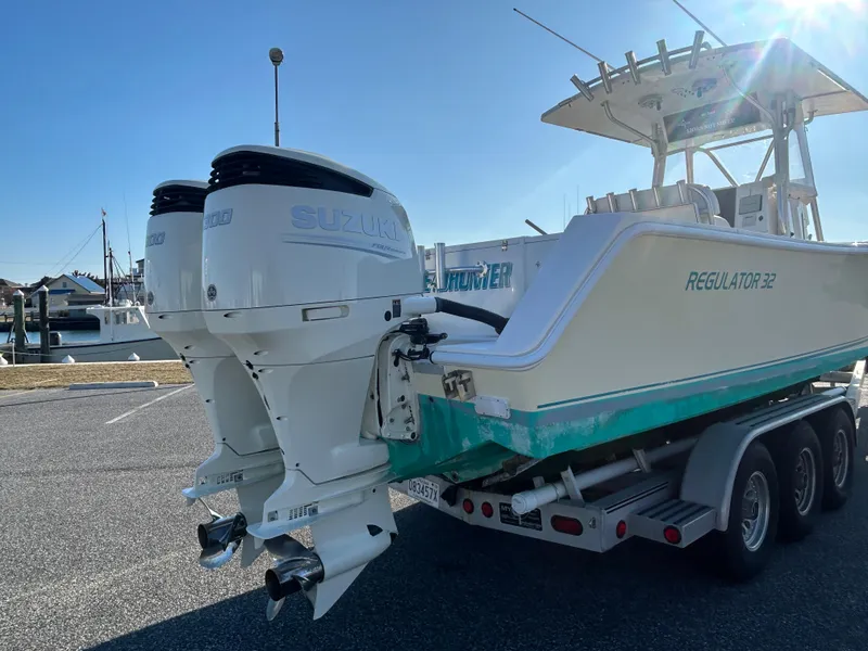 Slide: The Image of 2000 Regulator 32 Classic boat with dual Suzuki outboard motors on a trailer. - 4