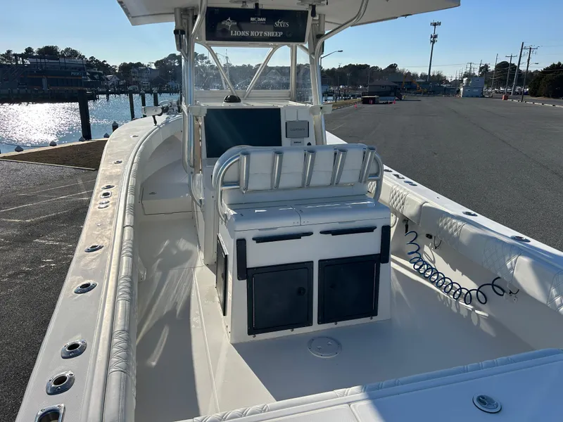 Slide: The Image of 2000 Regulator 32 Classic boat docked, featuring spacious deck and seating. - 7