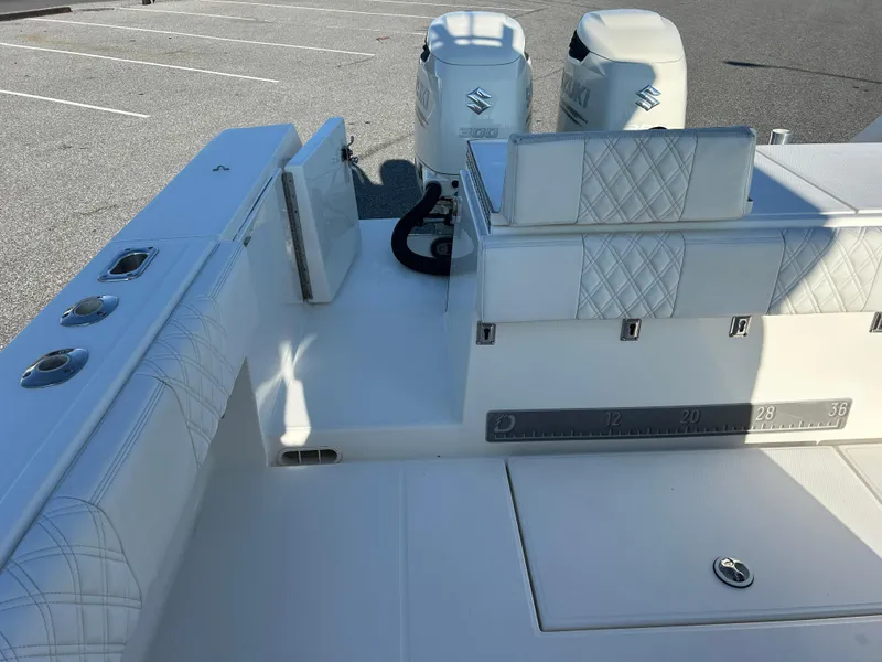 Slide: The Image of 2000 Regulator 32 Classic boat interior with white seating and dual Suzuki engines. - 8