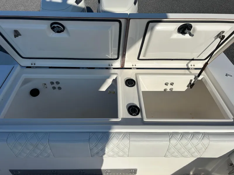 Slide: The Image of Open storage compartments on a 2000 Regulator 32 Classic boat. - 9