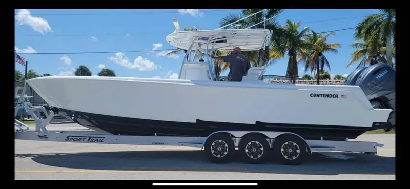 The Image of 2024 Contender 35 ST boat on trailer, palm trees in background. - 0