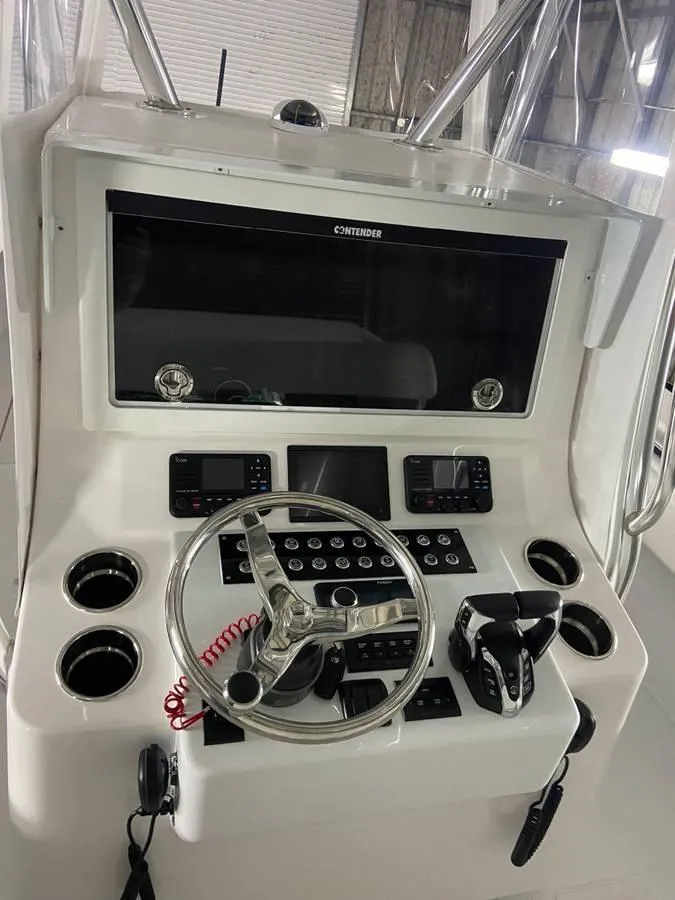 Slide: The Image of 2024 Contender 35 ST boat console with steering wheel and electronic controls. - 11