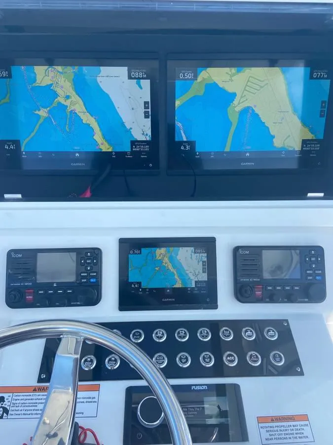 Slide: The Image of 2024 Contender 35 ST boat dashboard with navigation screens and controls. - 5