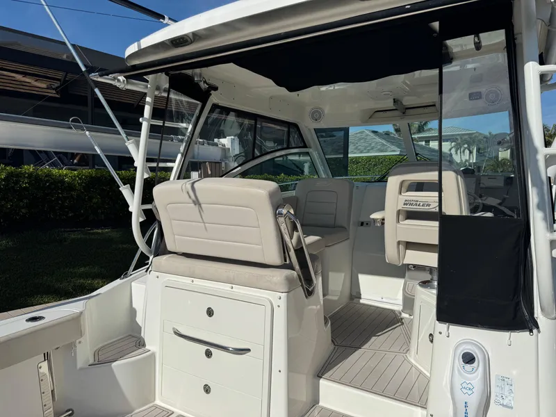 Slide: The Image of 2017 Boston Whaler 315 Conquest interior with seating and helm, showcasing luxury and functionality. - 12