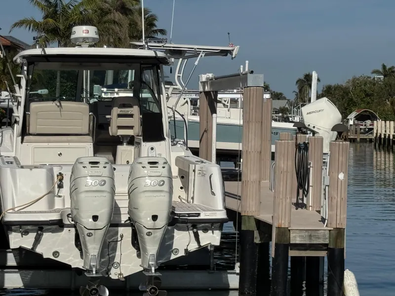 Slide: The Image of 2017 Boston Whaler 315 Conquest docked, featuring dual 300 horsepower engines. - 15
