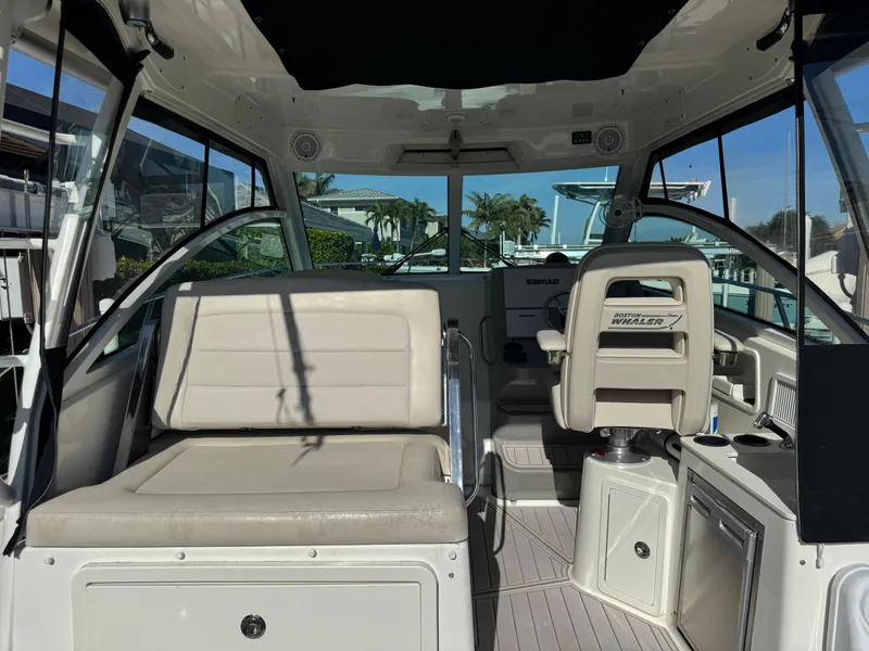 Slide: The Image of 2017 Boston Whaler 315 Conquest interior with seating and helm, showcasing luxury design. - 16