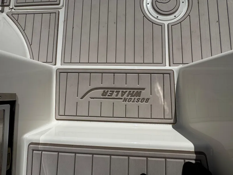 Slide: The Image of 2017 Boston Whaler 315 Conquest deck with logo, featuring sleek, durable design. - 19