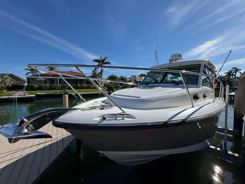 Slide: The Image of 2017 Boston Whaler 315 Conquest boat docked under clear blue sky. - 20