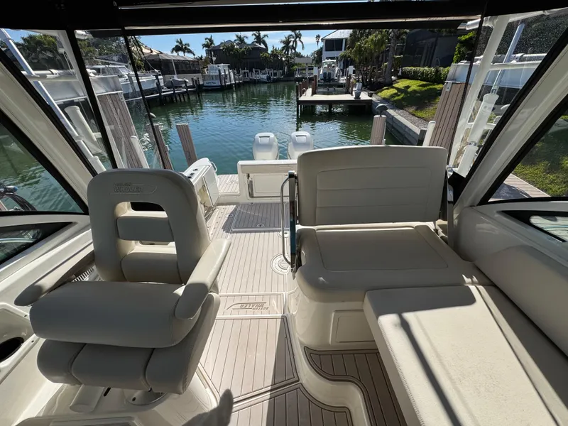 Slide: The Image of 2017 Boston Whaler 315 Conquest interior with seating, docked at marina. - 23