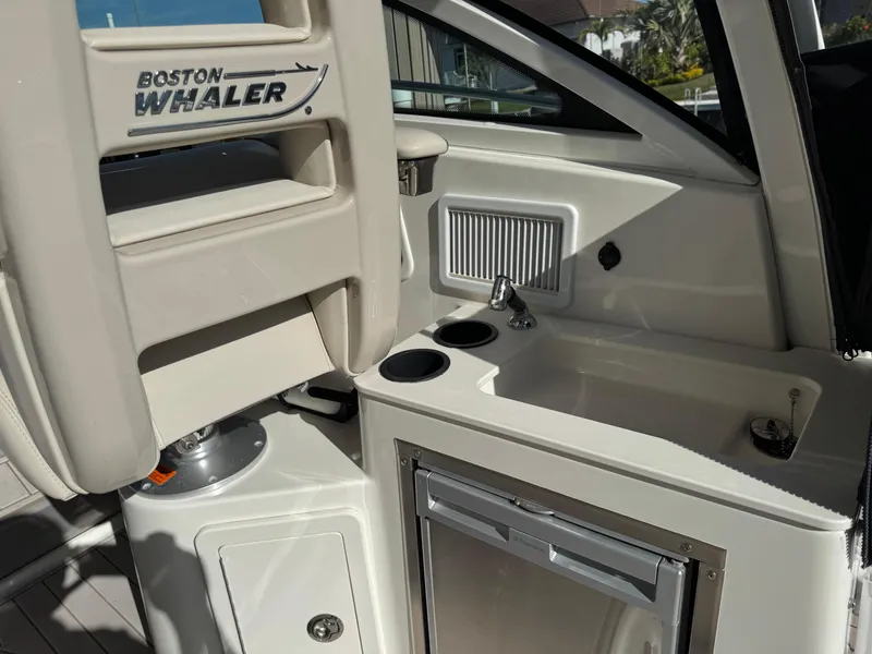 Slide: The Image of 2017 Boston Whaler 315 Conquest interior with sink and storage area. - 24