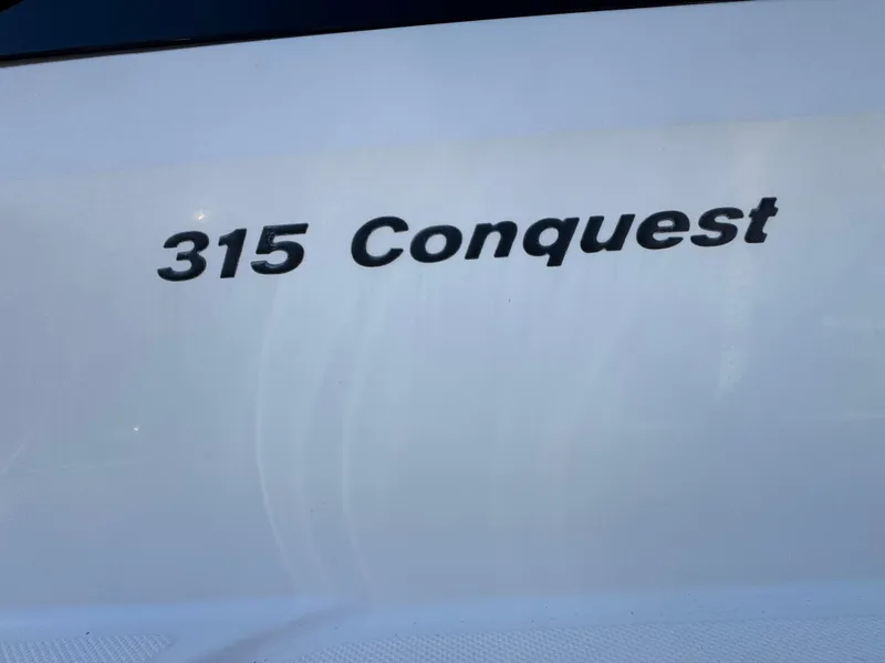 Slide: The Image of 2017 Boston Whaler 315 Conquest boat nameplate in bold black lettering. - 27