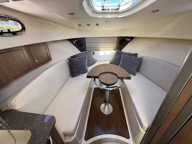 Slide: The Image of 2017 Boston Whaler 315 Conquest cabin interior with seating and table. - 31
