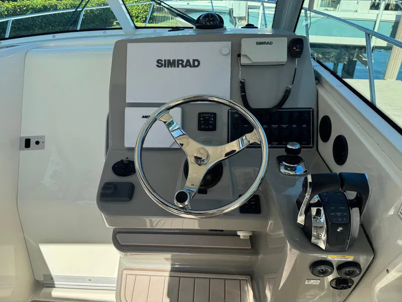 Slide: The Image of 2017 Boston Whaler 315 Conquest helm with Simrad electronics and steering wheel. - 4