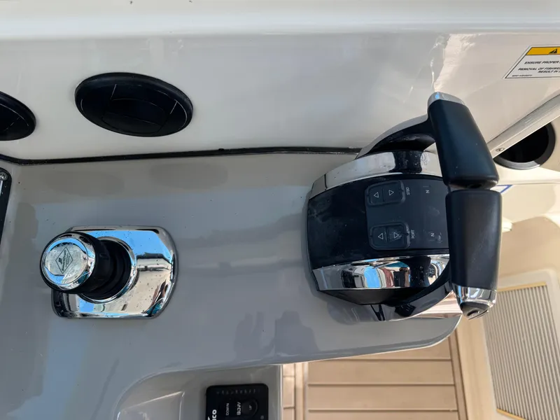 Slide: The Image of Control panel of a 2017 Boston Whaler 315 Conquest boat, featuring throttle and joystick. - 7