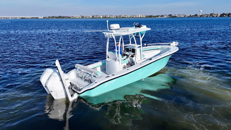 Slide: The Image of 2022 Yellowfin 26 Hybrid boat with twin 225 Mercury engines on calm water. - 11