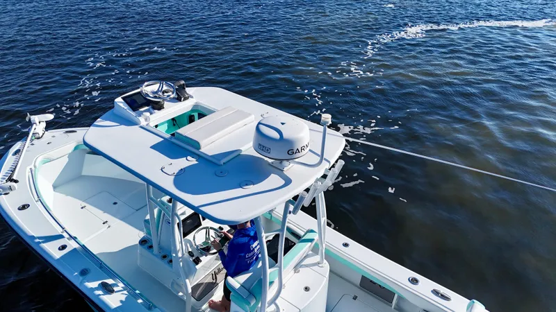 Slide: The Image of 2022 Yellowfin 26 Hybrid boat on water, equipped with Garmin technology. - 12