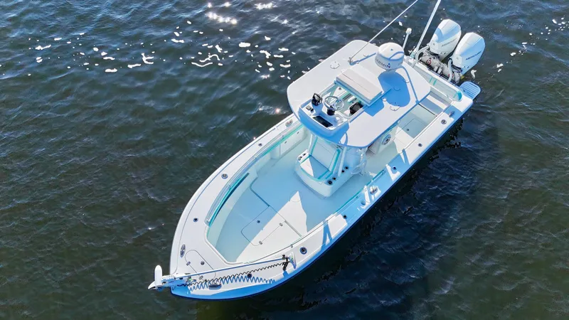 Slide: The Image of 2022 Yellowfin 26 Hybrid boat with twin 225 Mercury engines on water. - 14