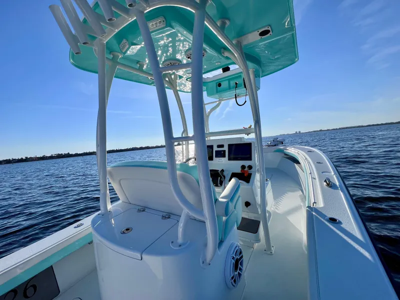 Slide: The Image of 2022 Yellowfin 26 Hybrid boat on water, featuring T-top and modern console. - 17