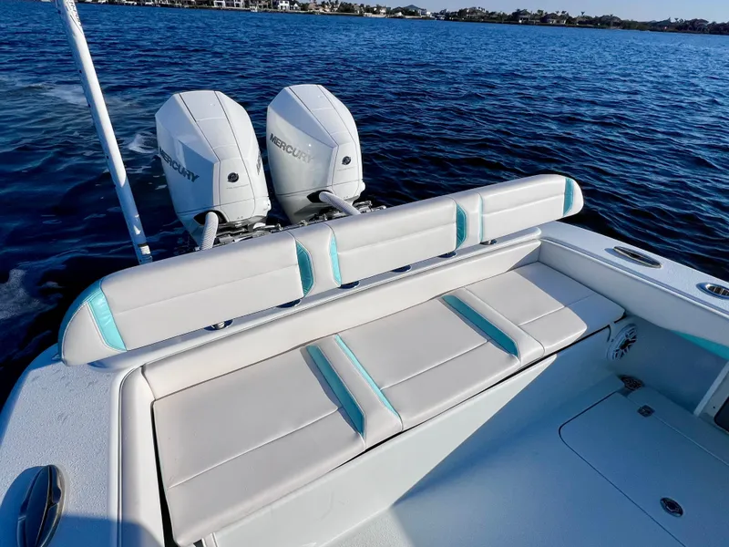 Slide: The Image of 2022 Yellowfin 26 Hybrid boat with twin 225 Mercury engines on a calm blue sea. - 18