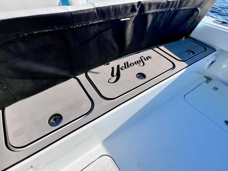 Slide: The Image of Yellowfin 26 Hybrid boat deck, 2022 model, featuring storage compartments. - 19
