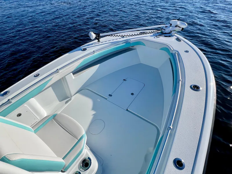 Slide: The Image of 2022 Yellowfin 26 Hybrid boat, spacious deck, sleek design, on calm water. - 29