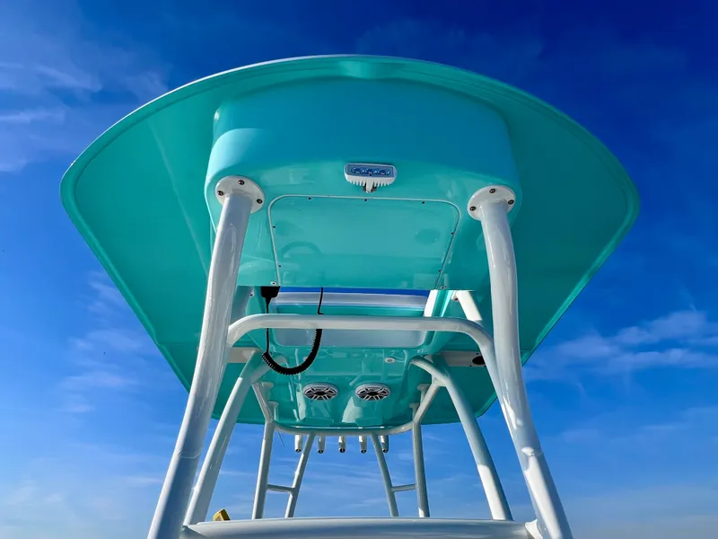 Slide: The Image of 2022 Yellowfin 26 Hybrid boat, turquoise T-top, clear blue sky background. - 34