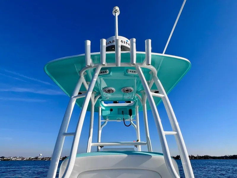 Slide: The Image of 2022 Yellowfin 26 Hybrid boat with T-top, clear blue sky background. - 35