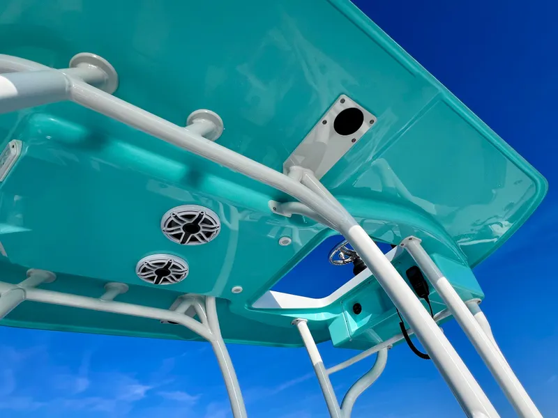 Slide: The Image of 2022 Yellowfin 26 Hybrid boat canopy with speakers, vibrant turquoise color against blue sky. - 36