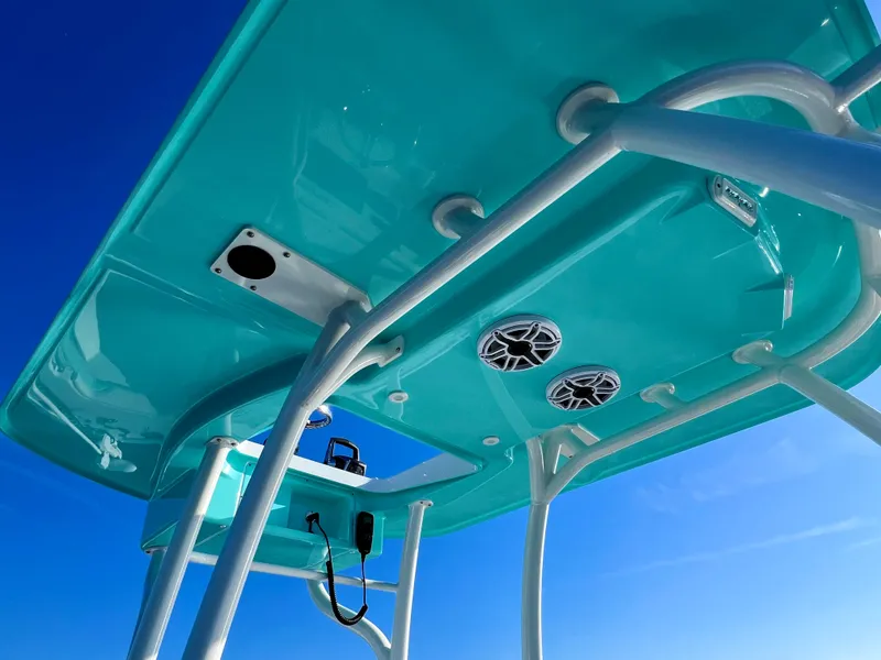 Slide: The Image of 2022 Yellowfin 26 Hybrid boat's turquoise canopy with speakers and support structure. - 37