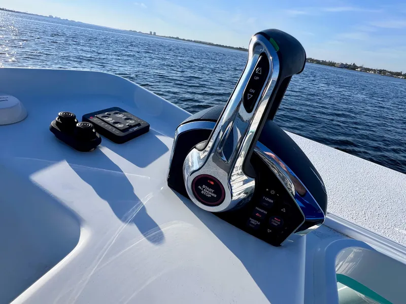 Slide: The Image of Control panel of 2022 Yellowfin 26 Hybrid boat with Mercury engines, on open water. - 41