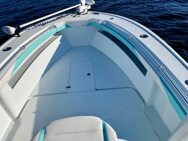 Slide: The Image of 2022 Yellowfin 26 Hybrid boat interior, featuring spacious seating and sleek design on calm water. - 46