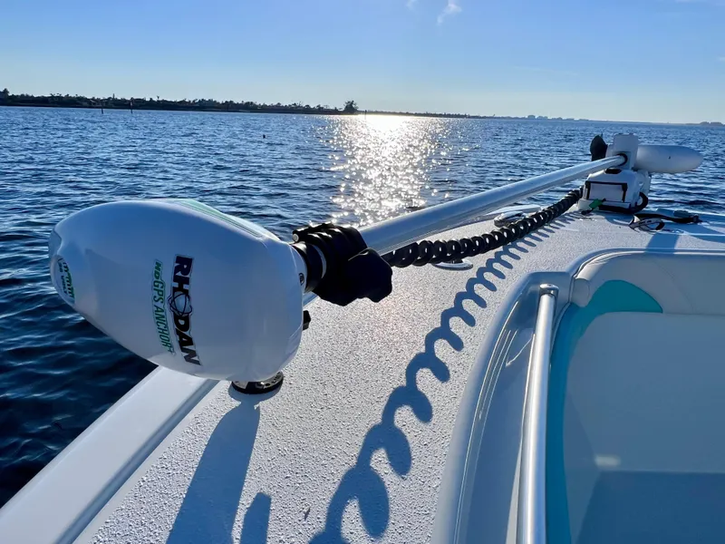 Slide: The Image of 2022 Yellowfin 26 Hybrid boat on water, featuring Rhodan trolling motor. - 48