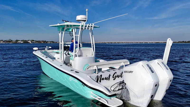 Slide: The Image of 2022 Yellowfin 26 Hybrid boat with twin 225 Mercury engines on calm water. - 7