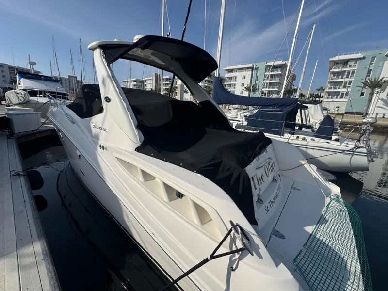 Slide: The Image of 2007 Sea Ray 310 Sundancer docked at marina, covered in black canvas. - 3