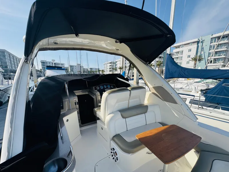 Slide: The Image of 2007 Sea Ray 310 Sundancer boat interior with seating and table, docked at marina. - 5
