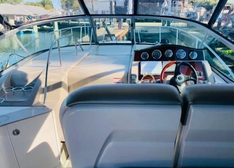 Slide: The Image of 2007 Sea Ray 310 Sundancer boat interior with helm and seating area. - 7