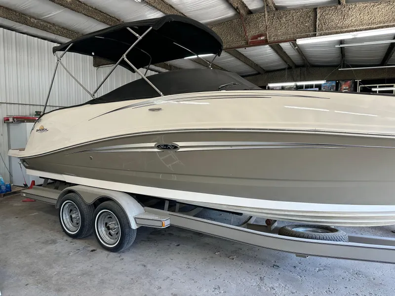 The Image of 2007 Sea Ray 260 Sundeck boat on trailer in indoor storage facility. - 0
