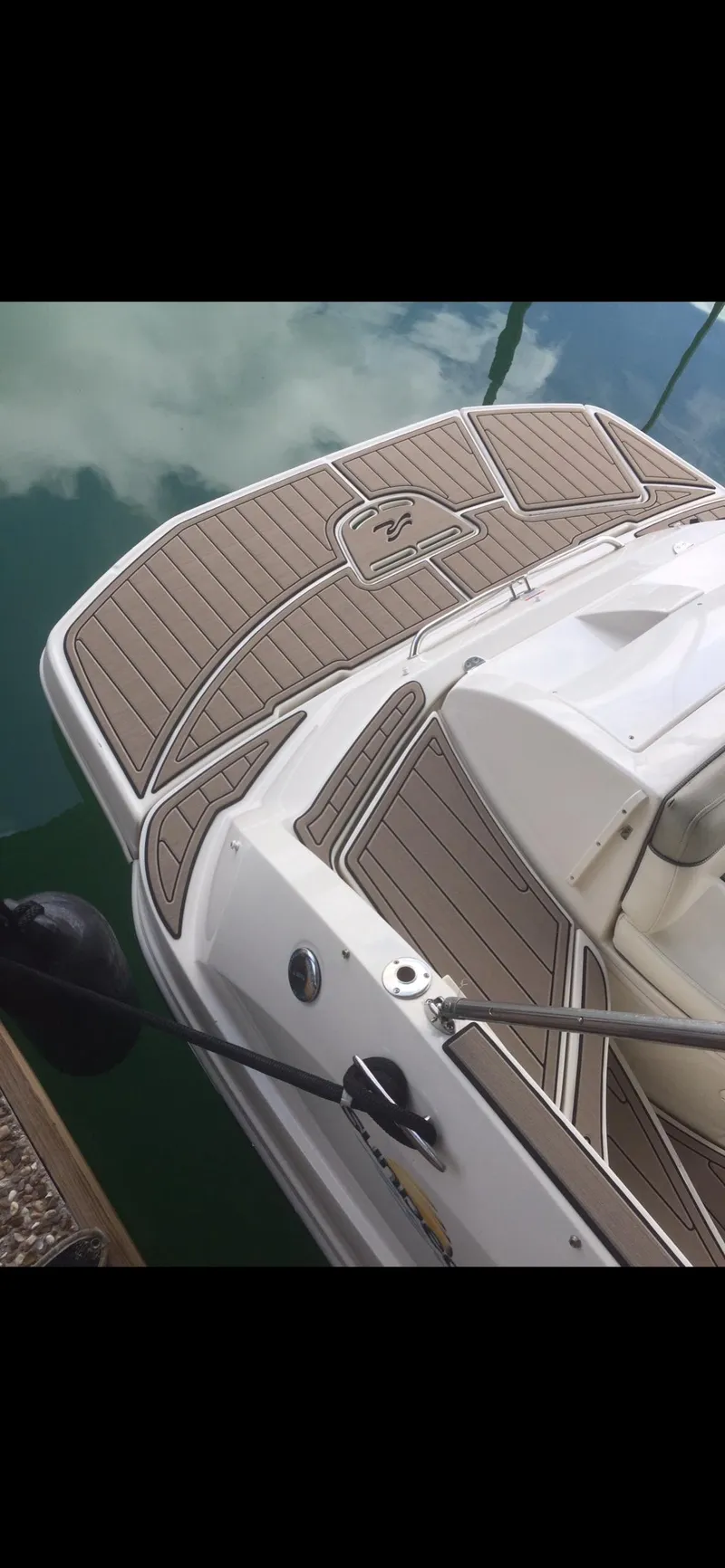 Slide: The Image of 2007 Sea Ray 260 Sundeck boat with teak deck, docked on calm water. - 14