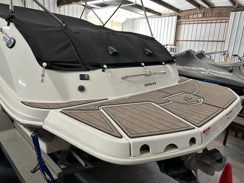 Slide: The Image of 2007 Sea Ray 260 Sundeck boat with covered deck in storage facility. - 2