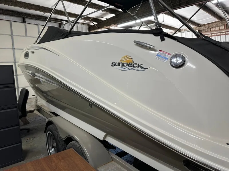 Slide: The Image of 2007 Sea Ray 260 Sundeck boat in storage, side view with logo visible. - 3