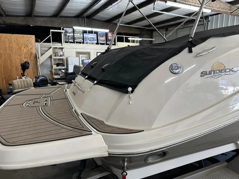 Slide: The Image of 2007 Sea Ray 260 Sundeck boat in storage, featuring a covered deck and sleek design. - 4