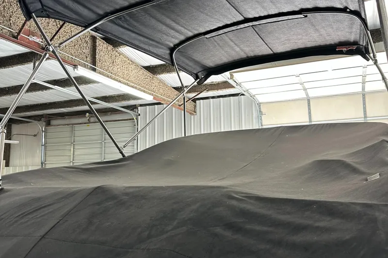 Slide: The Image of 2007 Sea Ray 260 Sundeck covered in storage, featuring a protective canopy. - 9