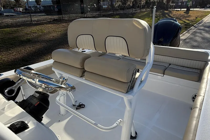 Slide: The Image of 2017 Sea Fox 246 Commander boat interior with cushioned seating and steering console. - 12