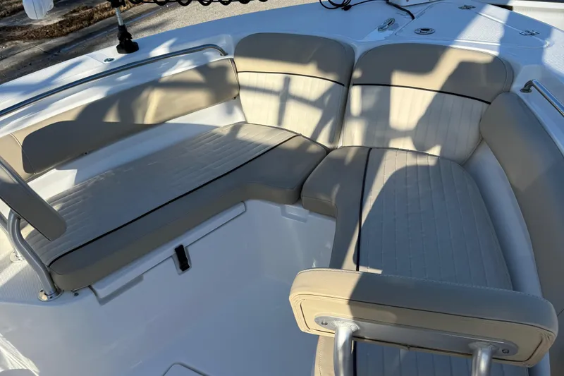 Slide: The Image of 2017 Sea Fox 246 Commander boat seating area with beige cushions and stainless steel accents. - 13