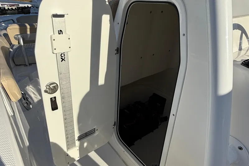 Slide: The Image of 2017 Sea Fox 246 Commander boat storage compartment with open door. - 22