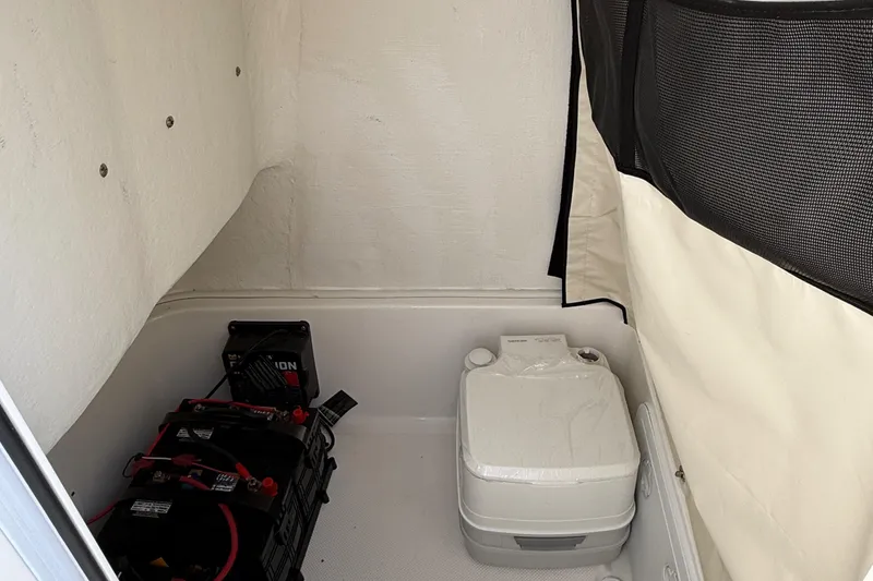 Slide: The Image of 2017 Sea Fox 246 Commander interior with portable toilet and battery storage. - 23