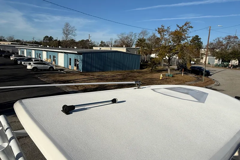 Slide: The Image of Rooftop view from a 2017 Sea Fox 246 Commander boat in a parking area. - 24