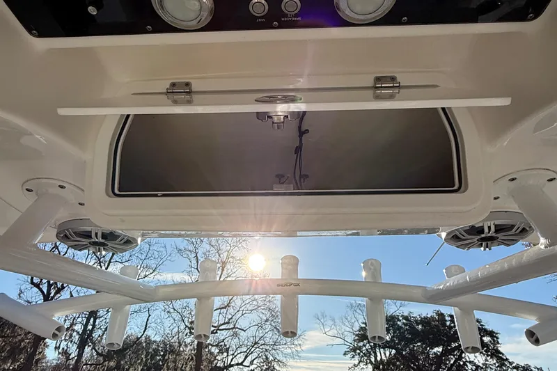 Slide: The Image of 2017 Sea Fox 246 Commander boat interior with rod holders and storage compartment. - 25