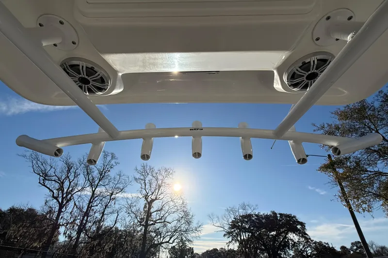 Slide: The Image of View from a 2017 Sea Fox 246 Commander boat, featuring rod holders and speakers under a clear sky. - 28